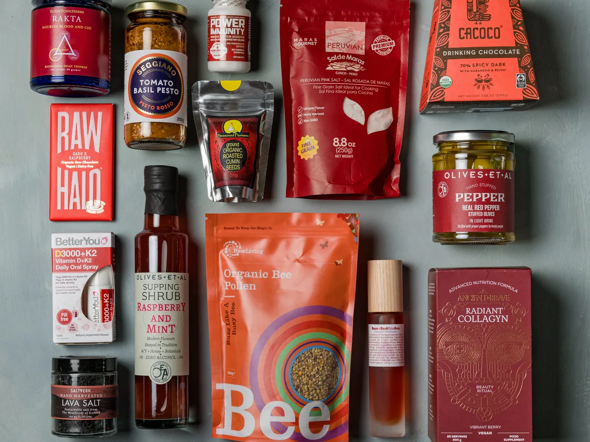 A Raw Living retail flatlay of superfoods, tonic herbs, ceremonial cacao and natural beauty products