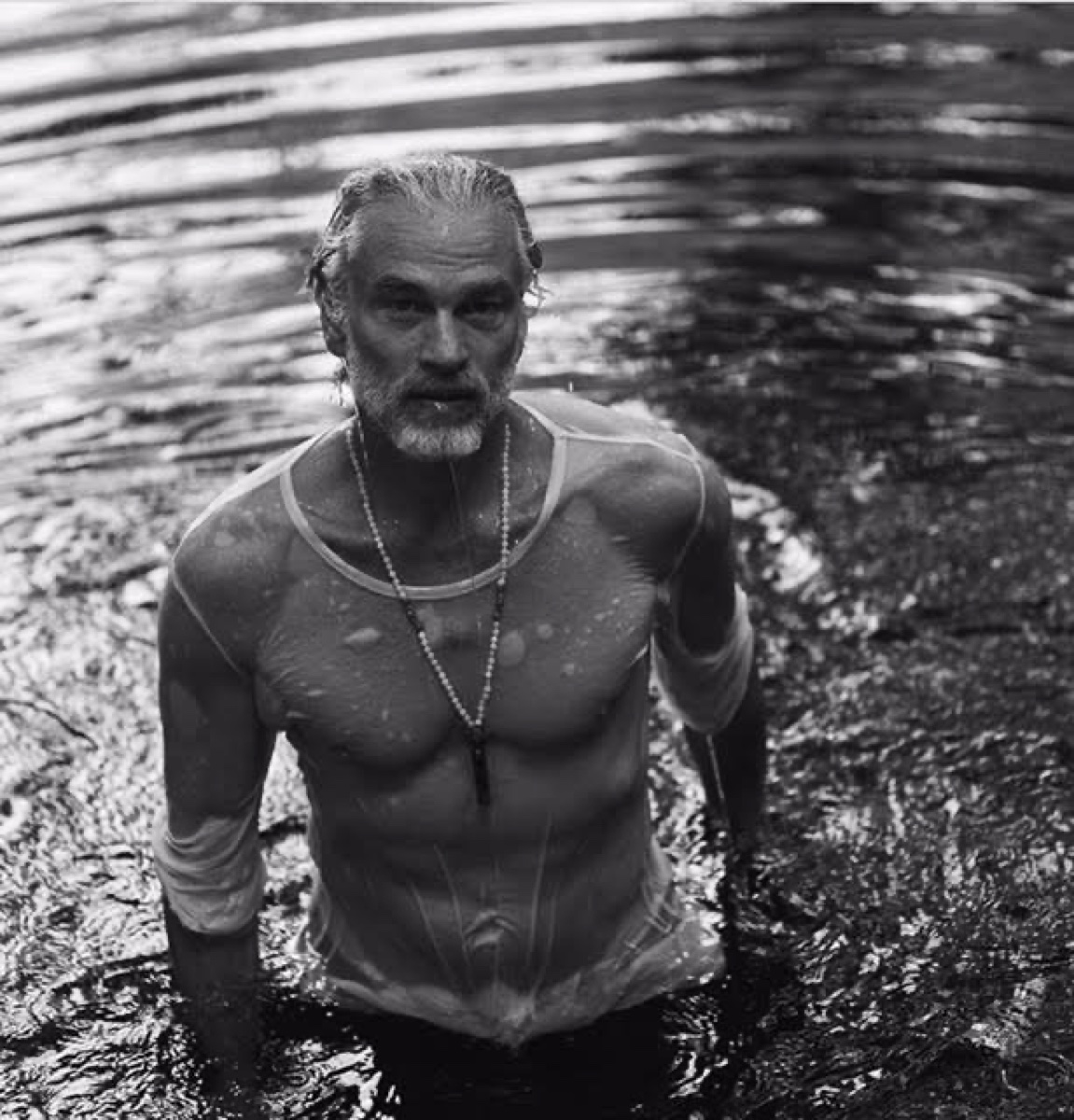 Hugo Woddis wearing the moonstone and labradorite necklace — black and white