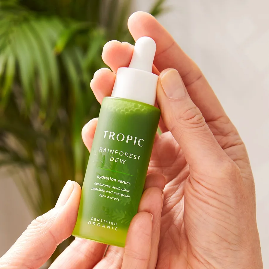 Tropic Rainforest Dew hydration serum held in hands